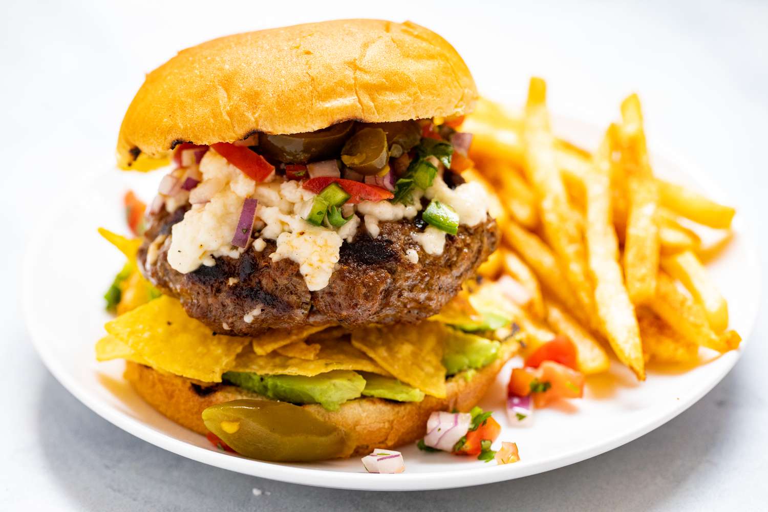 Nacho Mexican Burger with a side of fries.