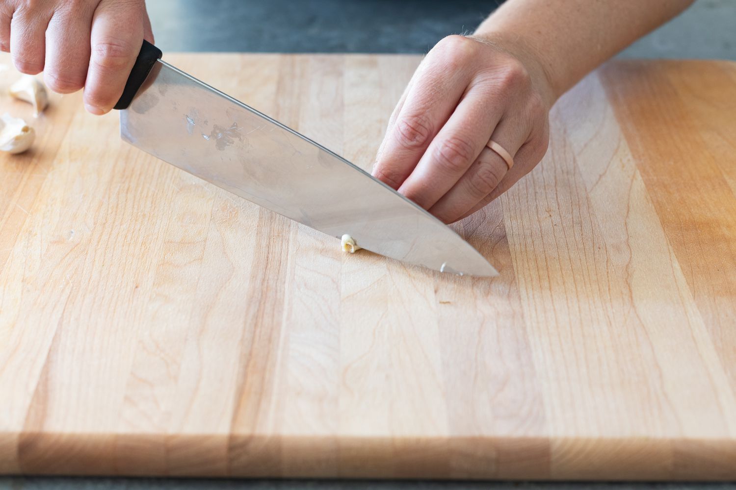 Trimming the hard end of a garlic clove