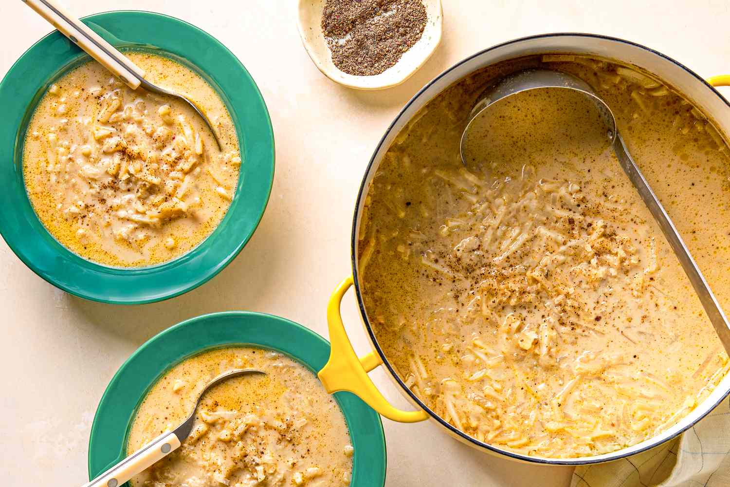 Soup served in bowls with a pot of the same soup on the side