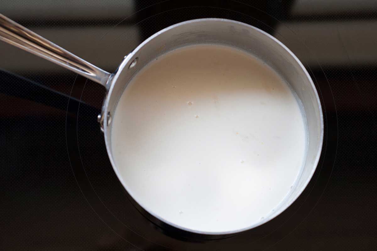 Vanilla Ice Cream with Chocolate and Marshmallows - heavy cream heating in pot on stove