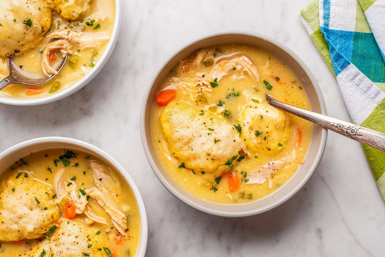 overhead view of Easy Chicken and Dumplings in bowls with spoons