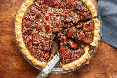 Chocolate pecan pie with bourbon with a couple slices cut.