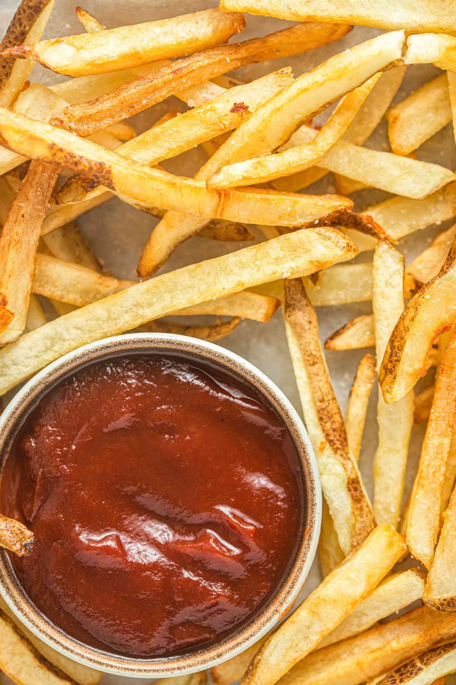 Closeup of Homemade French Fries Served with a Bowl of Ketchup