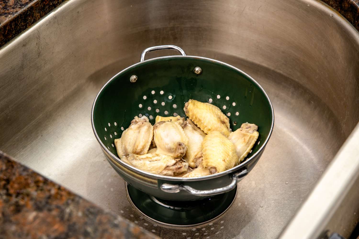 Wings Drained in a Colander in the Sink 
