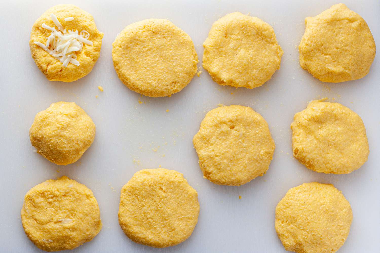 Flatten arepas into patties.