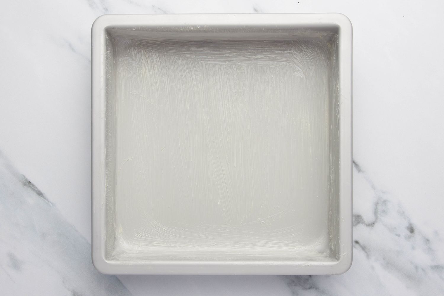 Buttered baking pan for lazy daisy cake recipe