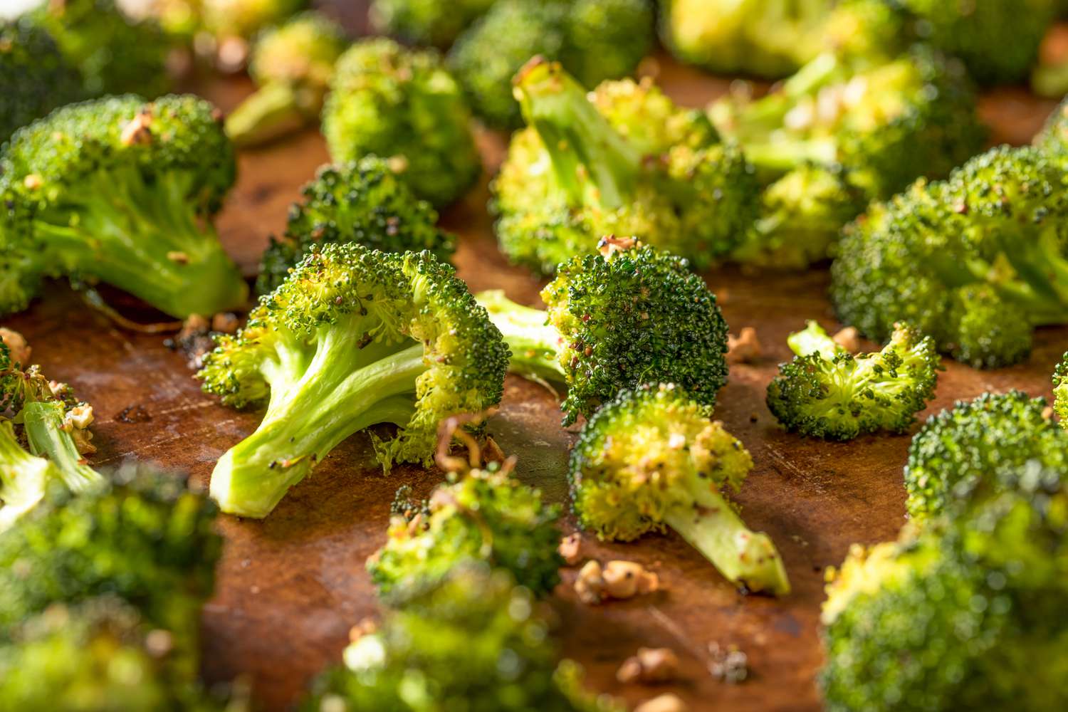 Roasted broccoli florets on a wooden counter
