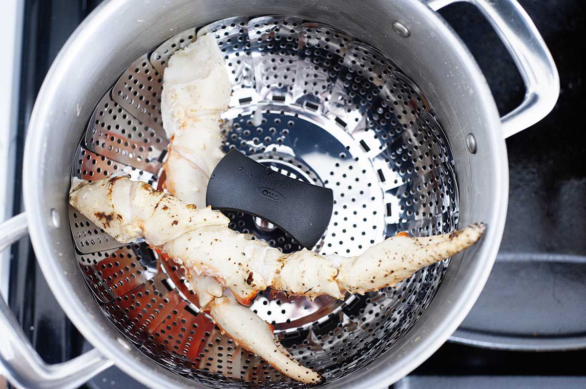 Krab legs in a pot to show how to cook king crab legs.