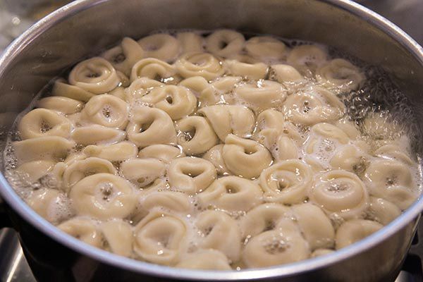 cheese tortellini being boiled in water