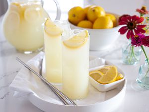 Homemade lemonade in tall glasses on a tray.