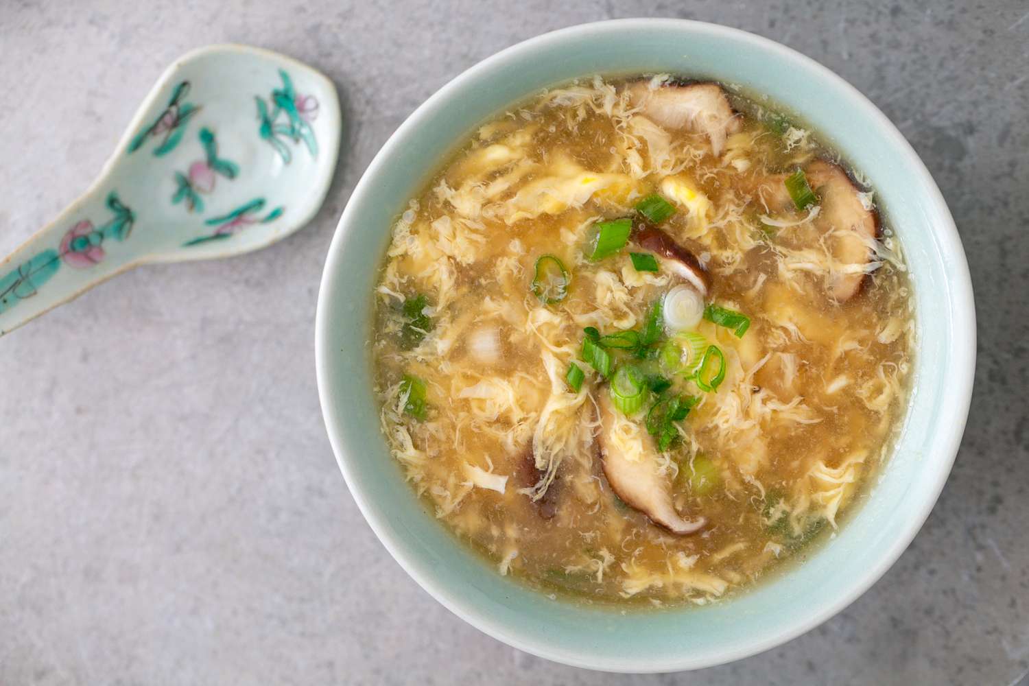 Bowl of egg drop soup with a spoon