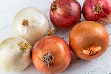 onions on the counter (yellow, white, and red)