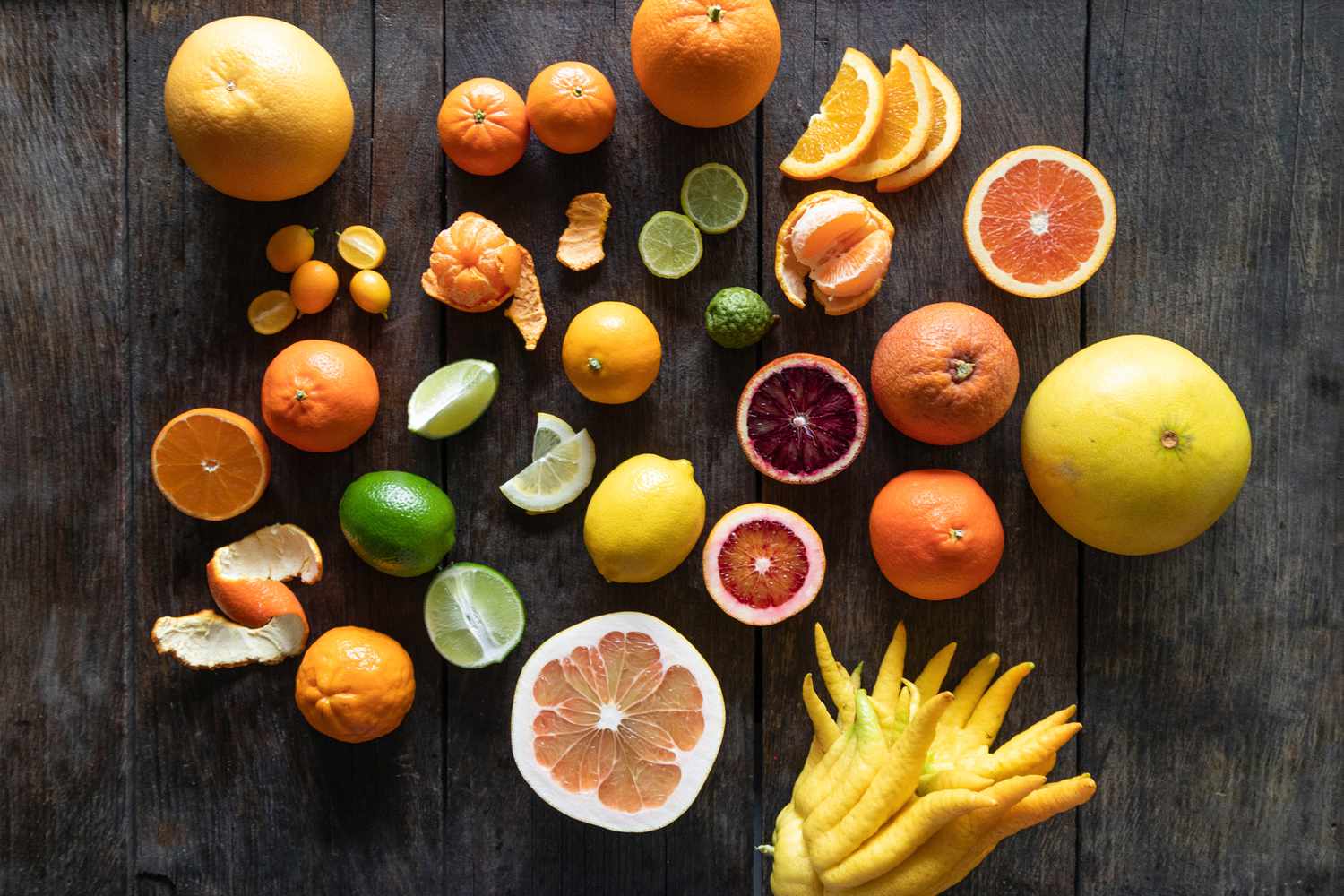 Citrus varieties on dark wood background