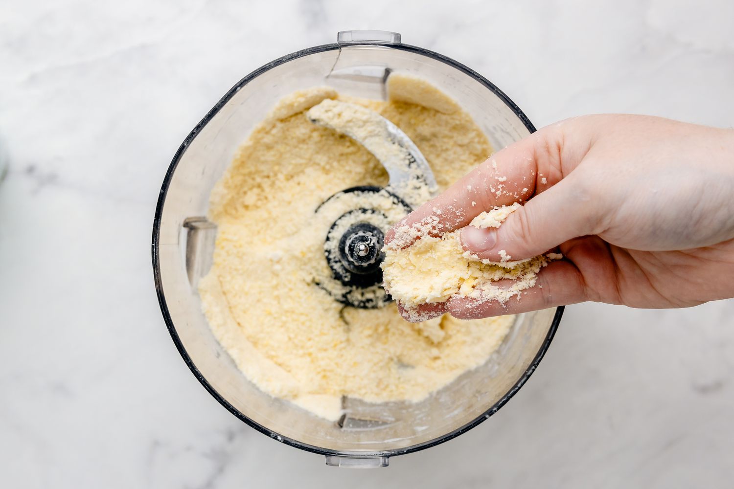 Hand Showing Texture of Dough Mixture for Bars Recipe