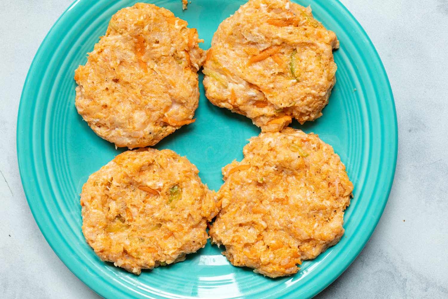 Buffalo chicken burger patties ready to be cooked.