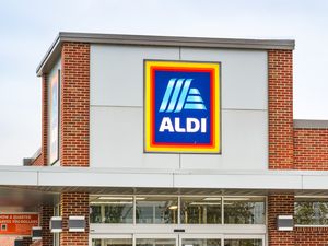 Storefront of Aldi with the logo prominently displayed on the building