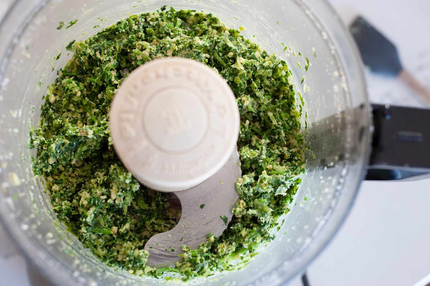 Making scallion pesto in food processor 