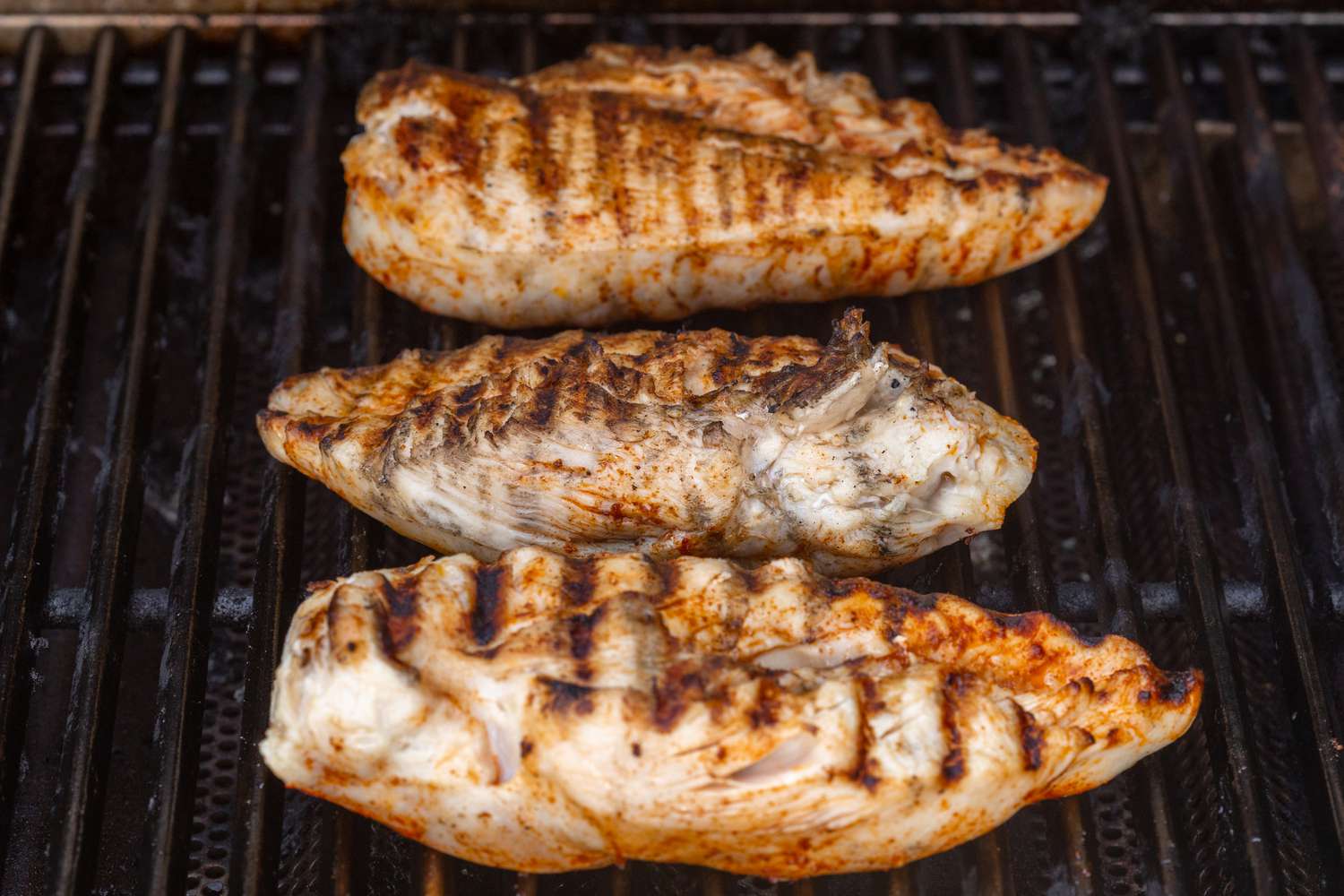 Chicken on the grill to show how long to grill chicken breast.
