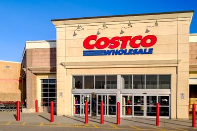 The storefront of a Costco Wholesale store with its name prominently displayed above the entrance