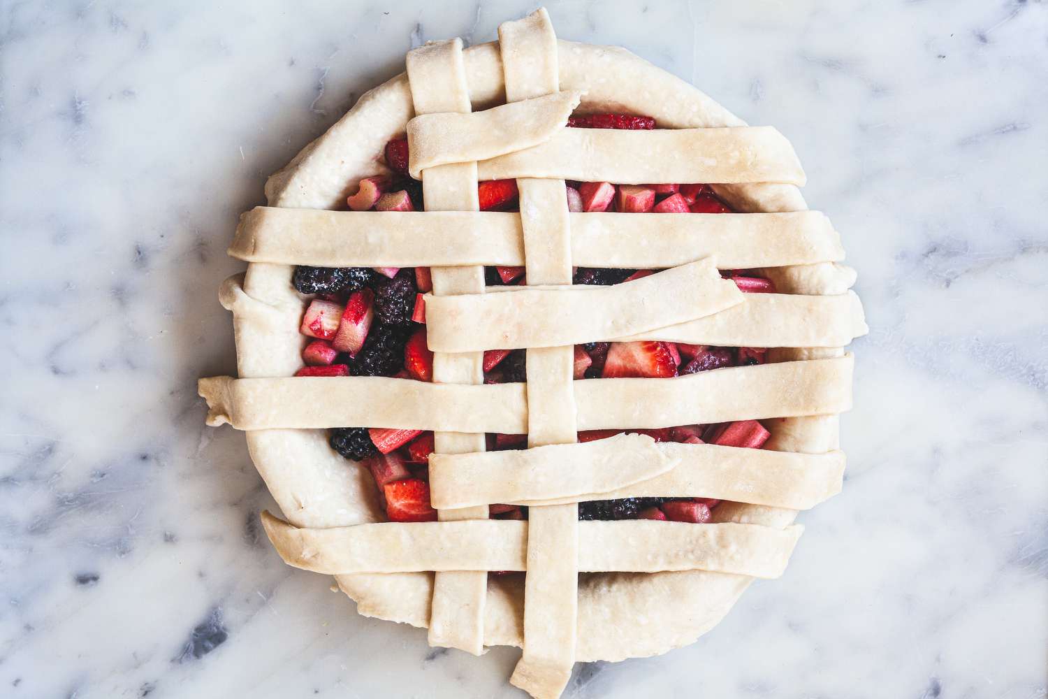 Weaving the strips of a lattice pie crust.