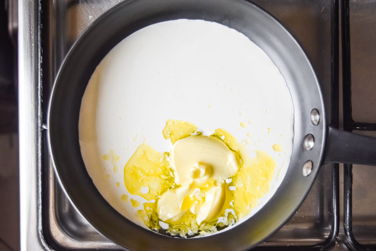 Butter Melting in a Pan of Cream over the Stove for Potatoes Mashed Recipe