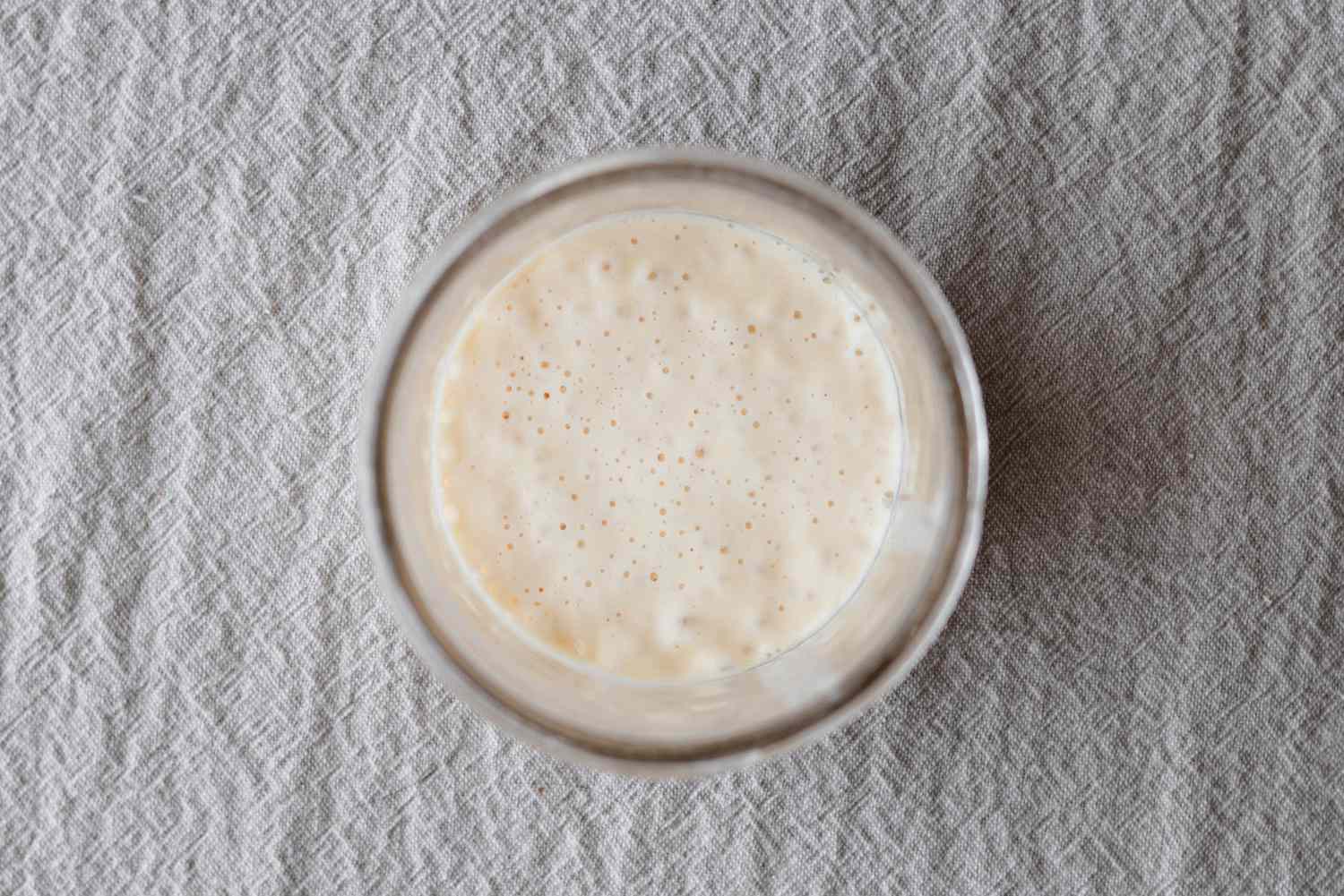 Sourdough starter recipe in a mason jar and viewed from overhead.