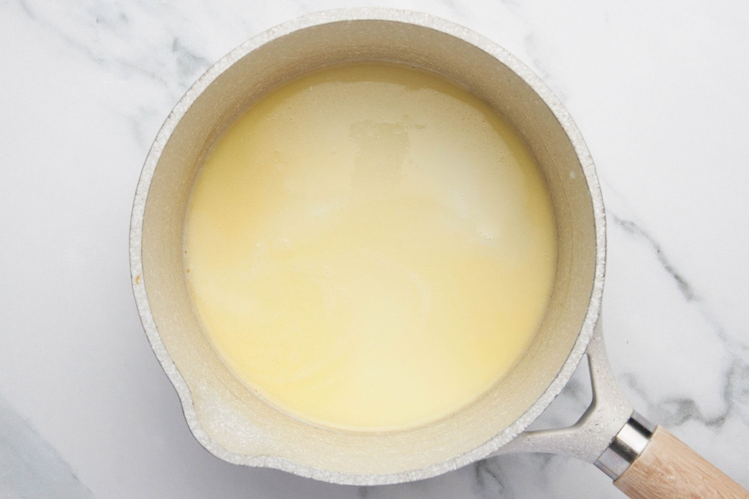 Butter and milk heated in a small pot for lazy daisy cake recipe 