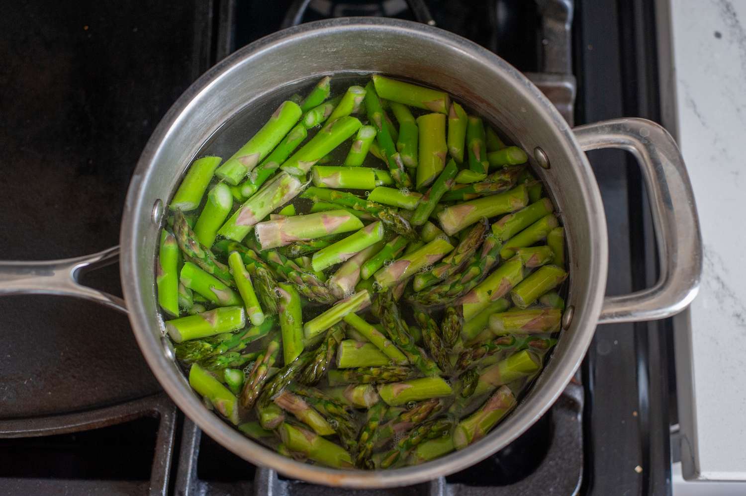 A pot with asparagus making an asparagus recipe.