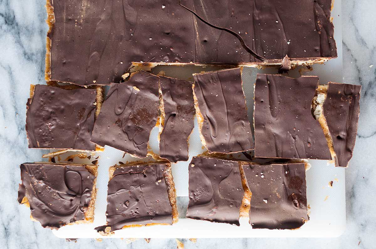 Overhead of the Christmas cracker candy being broken into bite-sized chunks