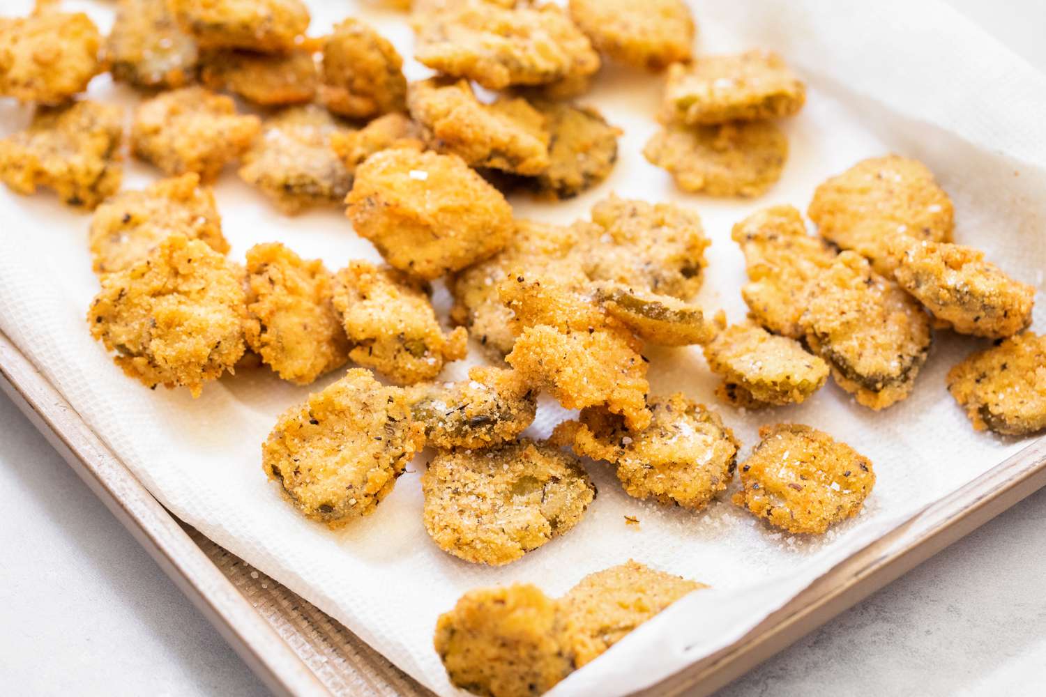 Fried Pickles on a Paper Towel Lined Baking Sheet