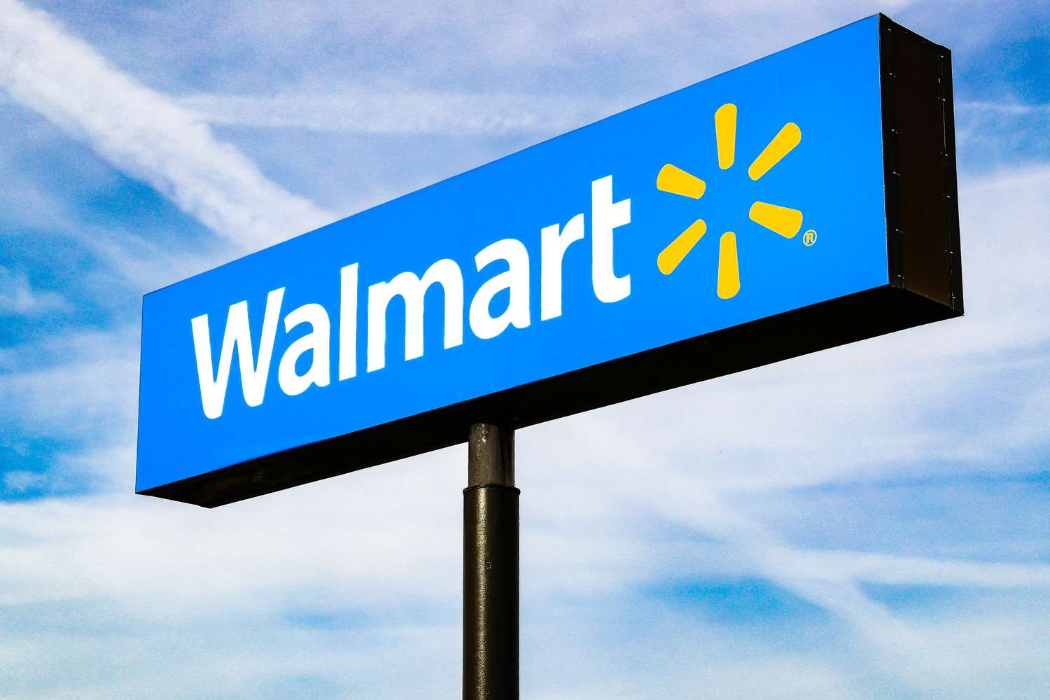 Walmart logo on a pole against the sky