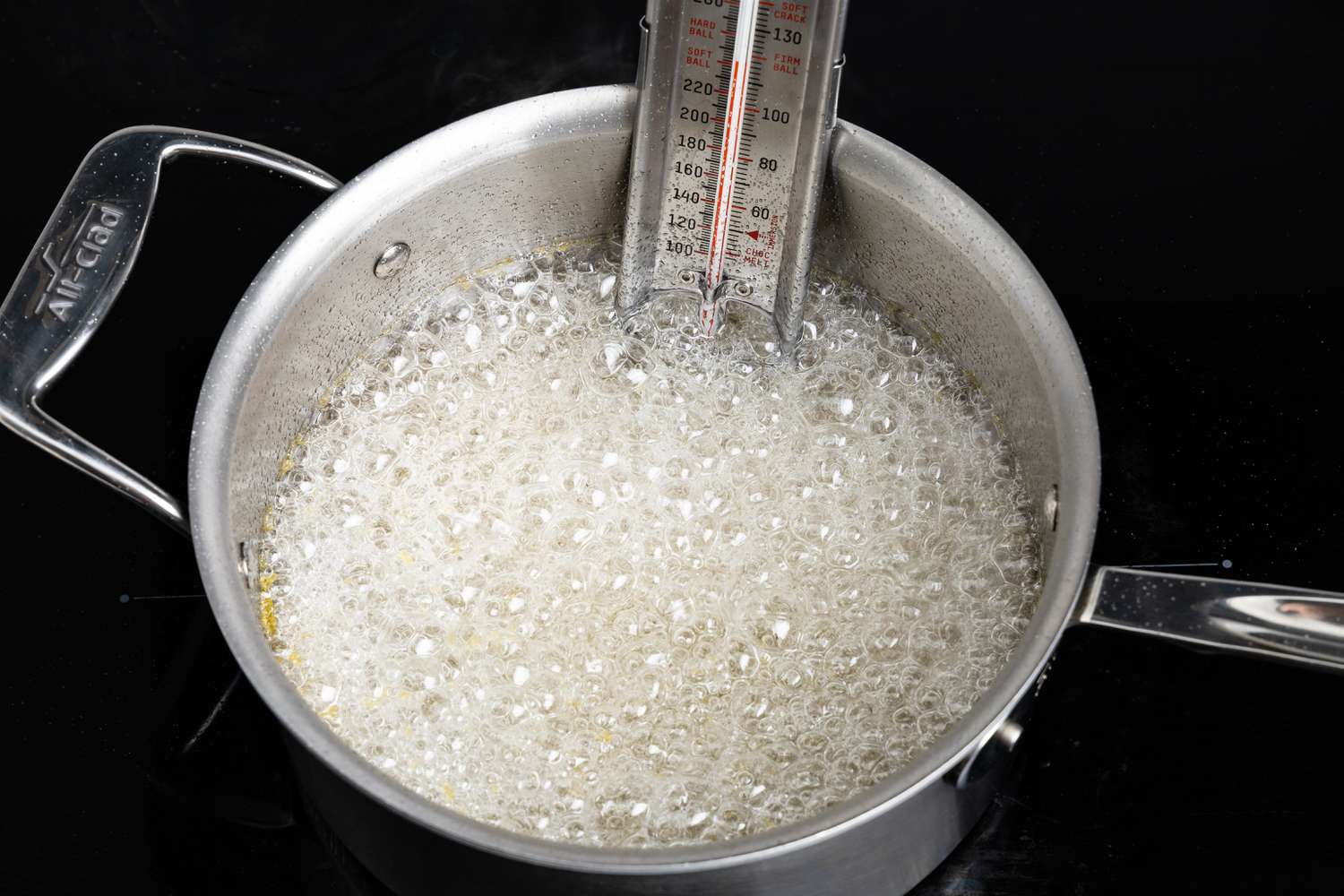 Turkish Delight Syrup Mixture Boiling in a Sauce Pan With a Candy Thermometer 