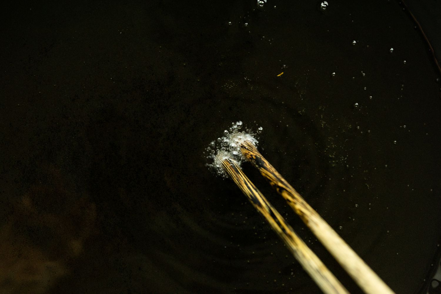Chopsticks Placed in Hot Oil to Check if Ready for Egg Foo Young Recipe