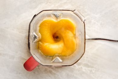 Blender with pureed butternut squash on a countertop