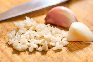 Garlic chopped on a wooden cutting board