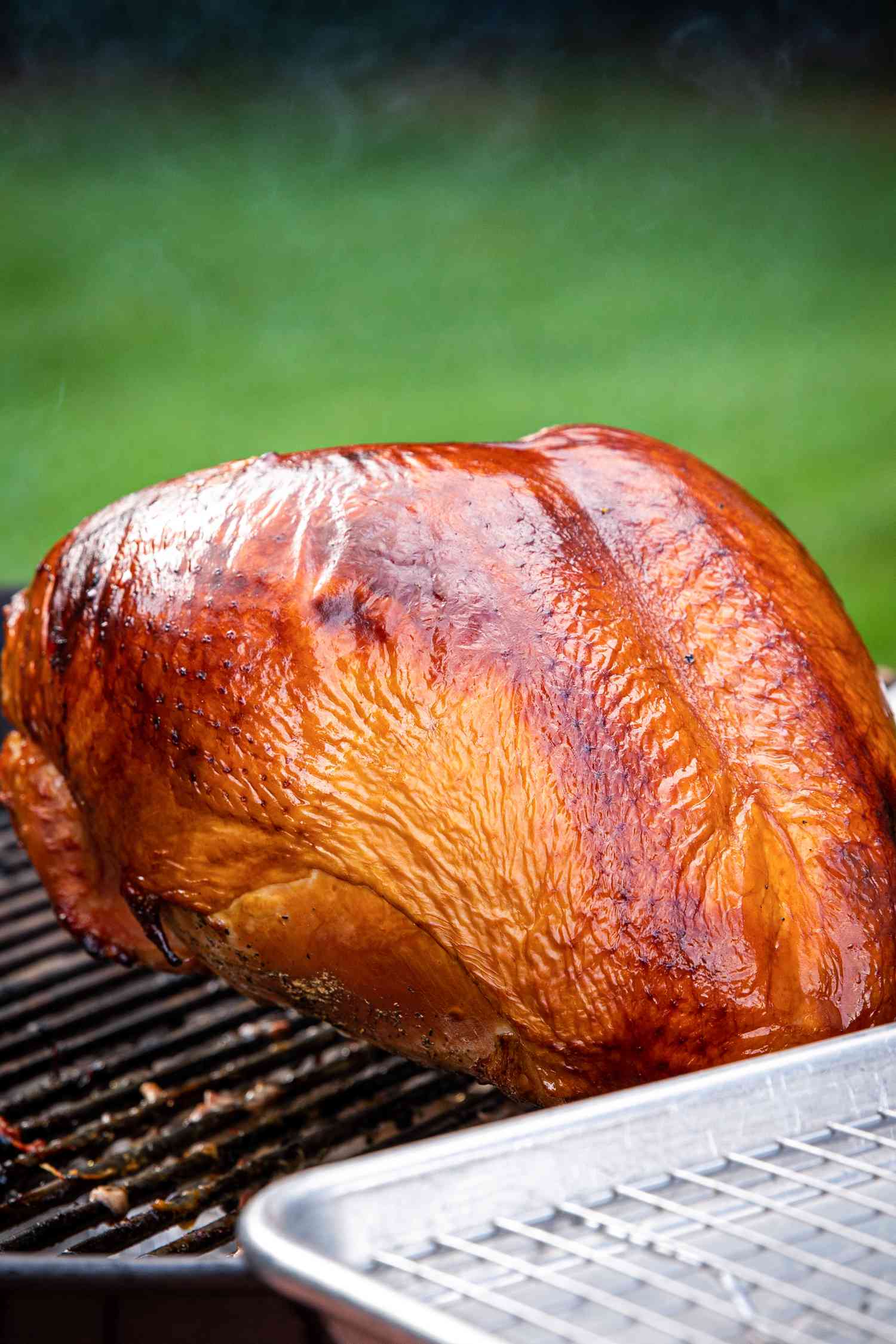 Cherry wood smoked turkey breast on a grill.