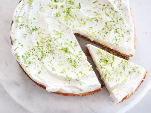 A slice of key lime cheesecake cut out. 