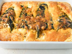 An uncut chili relleno casserole on a white background