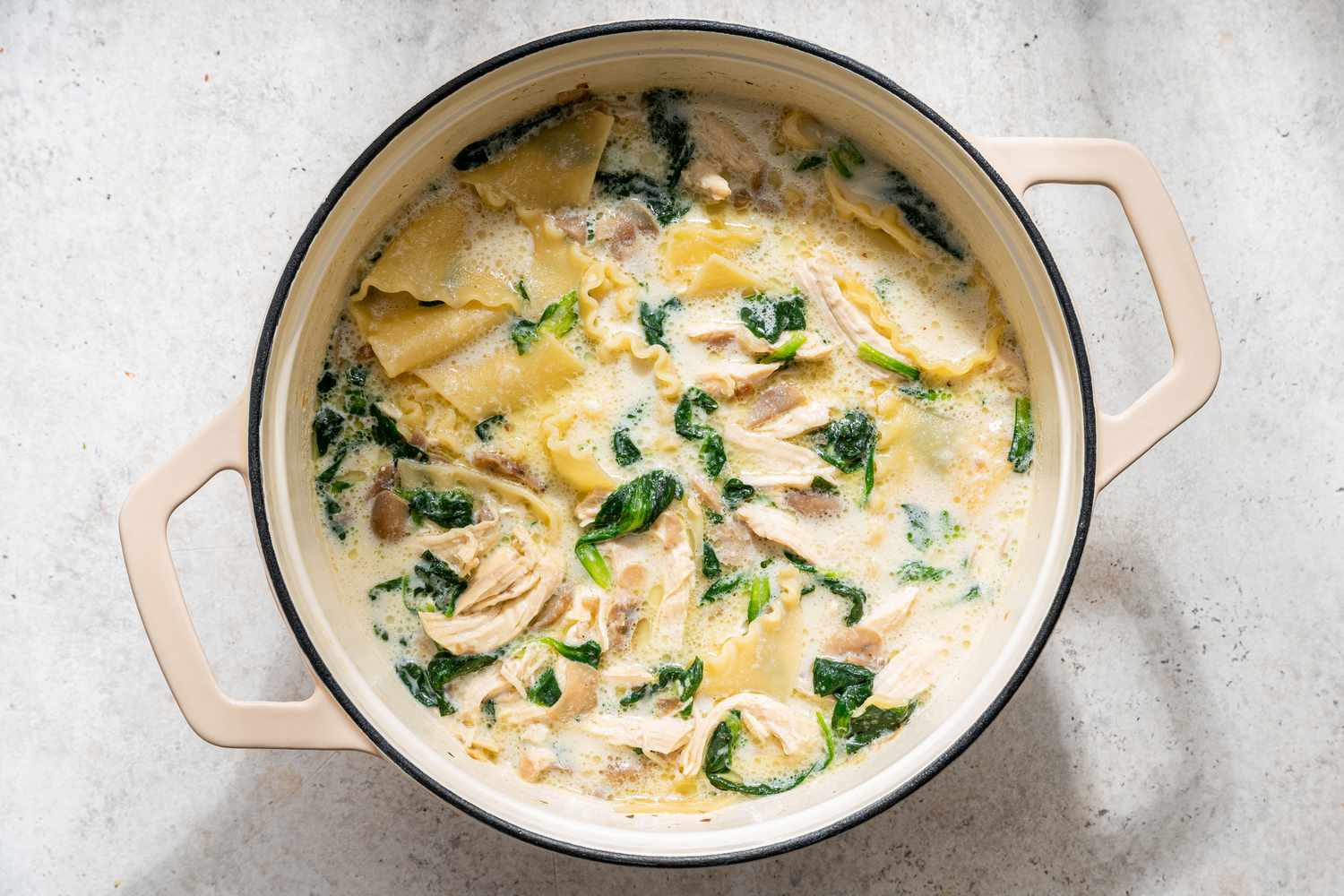 whole milk added to the white chicken lasagna soup in the dutch oven 