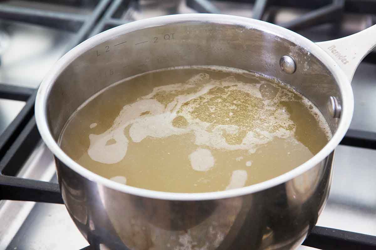 Warm stock in a pot for butternut squash risotto