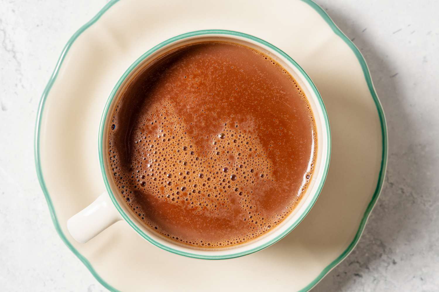 A cup of hot chocolate served on a matching saucer