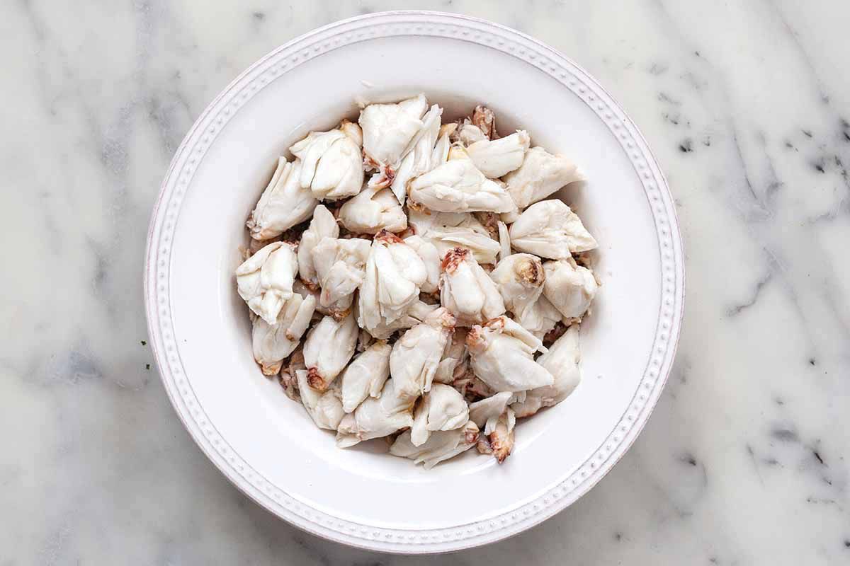 Lump crab meat on a white plate.