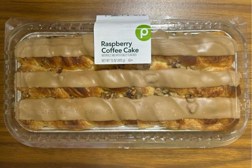 Packaged raspberry coffee cake with icing in a clear plastic container