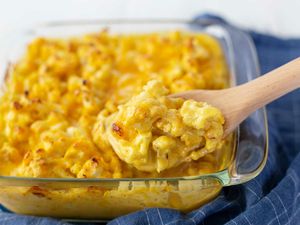 Scooping Easy Cauliflower Bake out of a glass casserole dish.