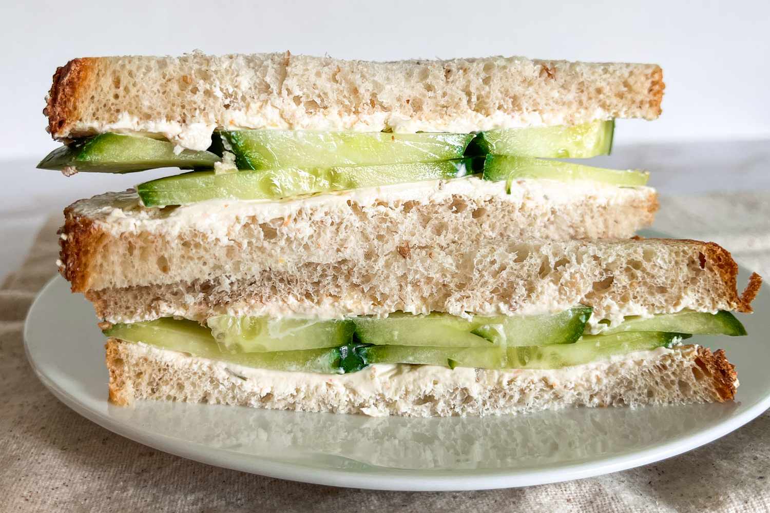 1-minute cucumber sandwich sliced in half and on a plate