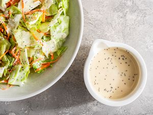 Teriyaki restaurant 3-ingredient dressing in a small white dish next to a salad