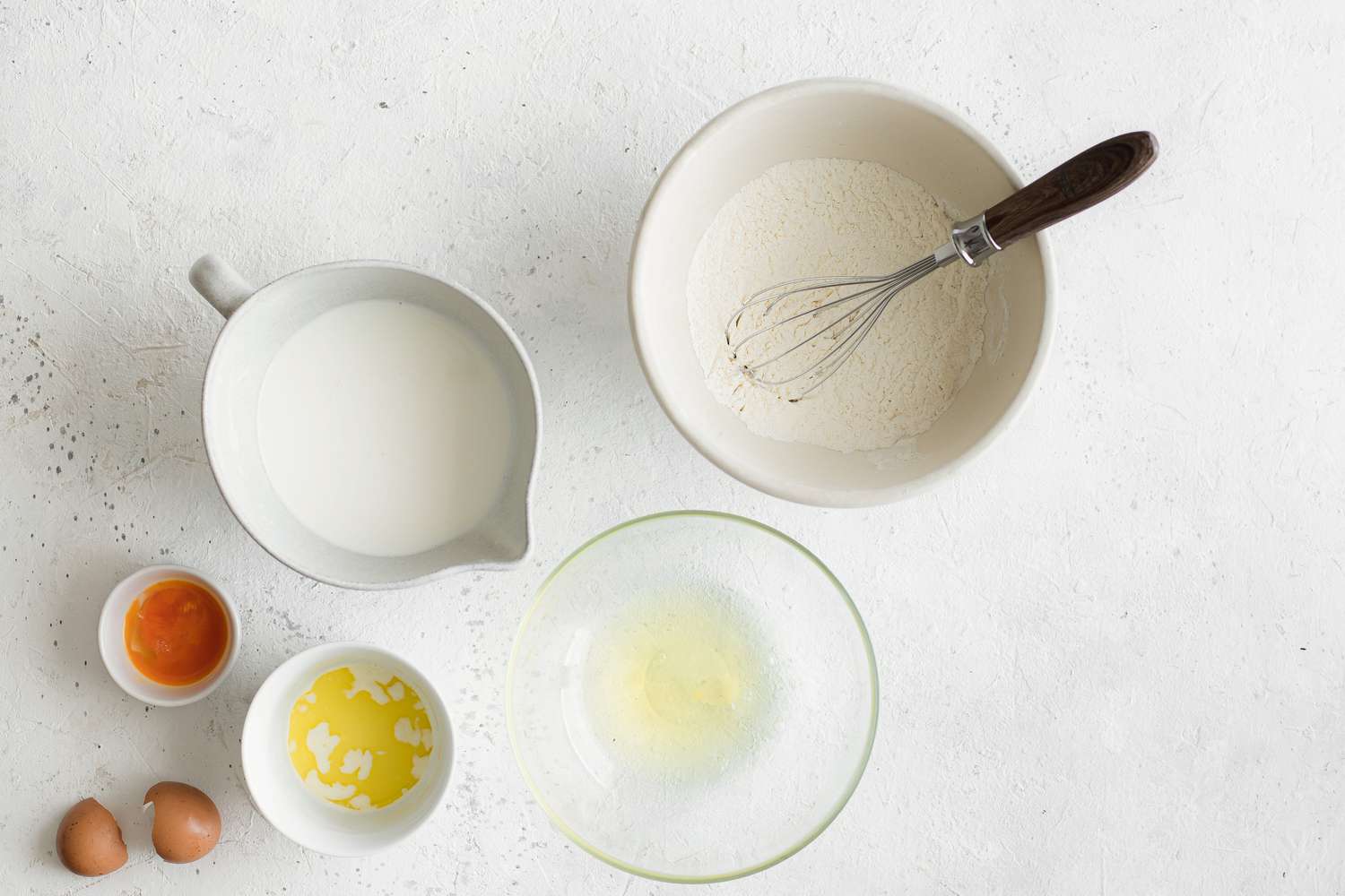 Sourdough Pancakes Ingredients (Left to Right): Bowl of Egg Yolks, Bowl of Milk, Bowl of Melted Butter, Bowl of Egg Whites, and a Bowl of All-Purpose Flour with a Whisk
