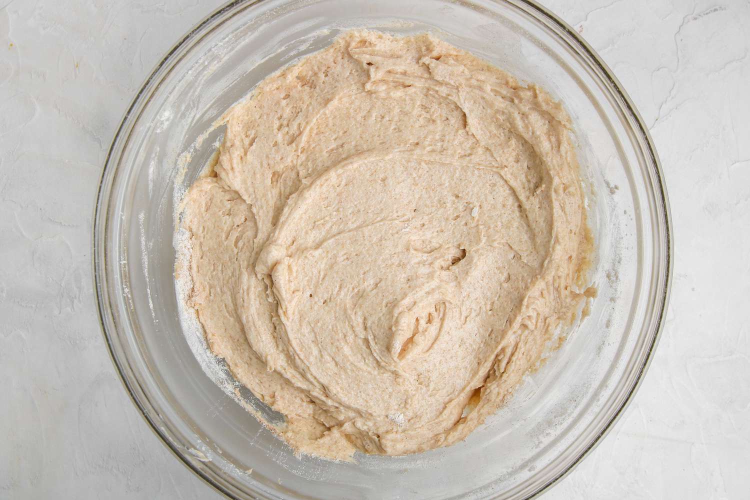 Cinnamon streusel apple bread batter in a glass bowl.