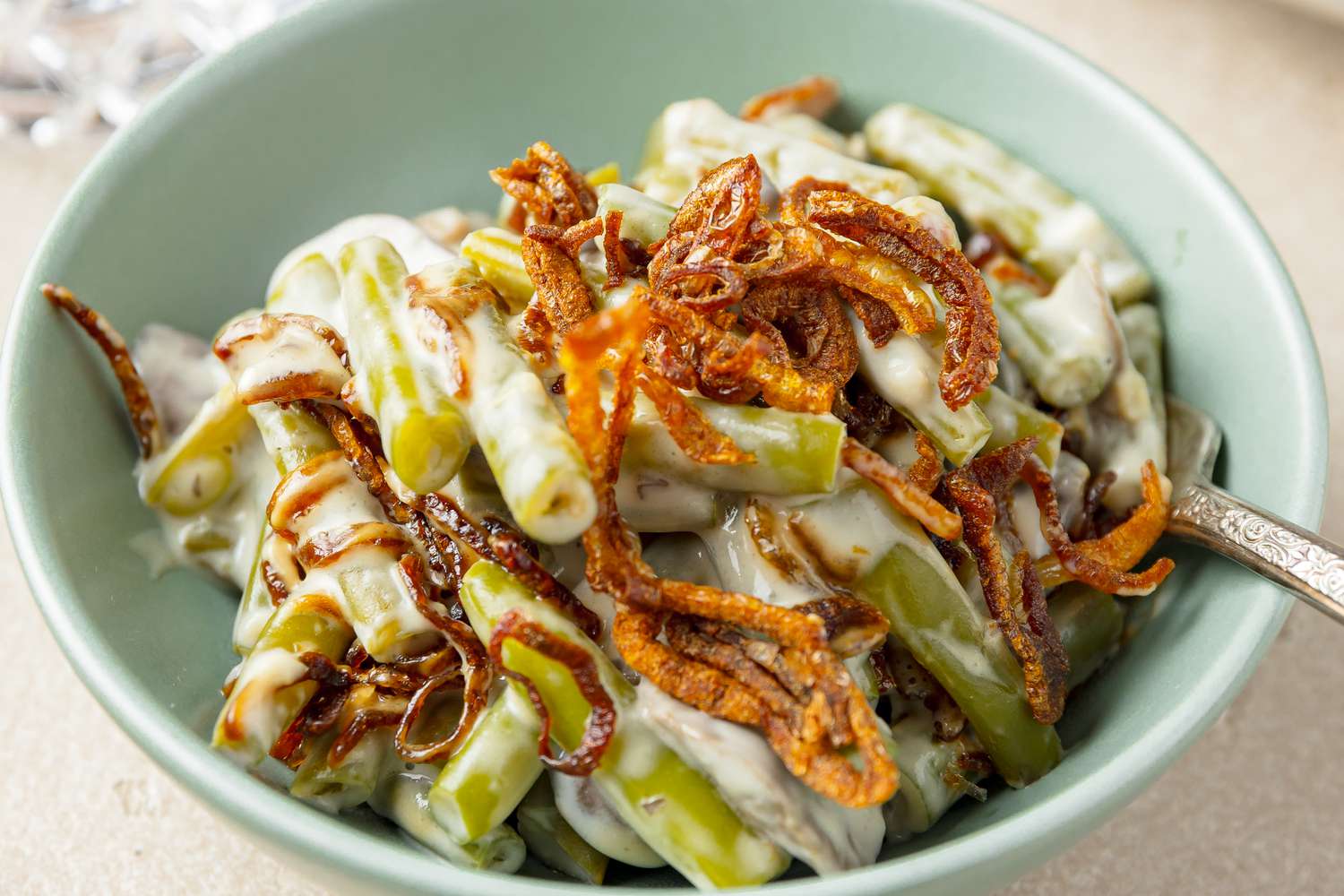 Small Bowl of Slow Cooker Green Bean Casserole Topped with Crispy Shallots 