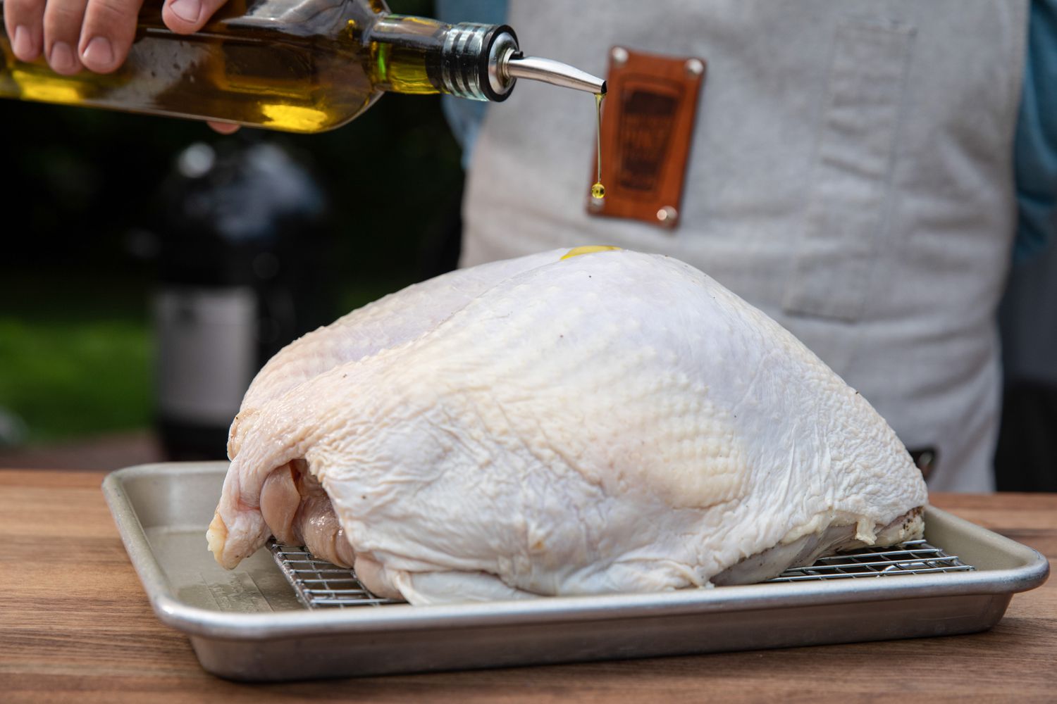 Oiling a turkey breast to make cherry wood smoked turkey breast.